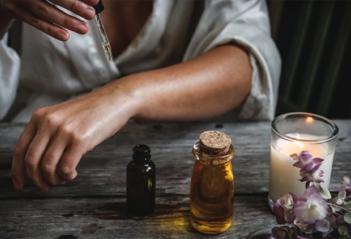 Woman applying oil to her skin.